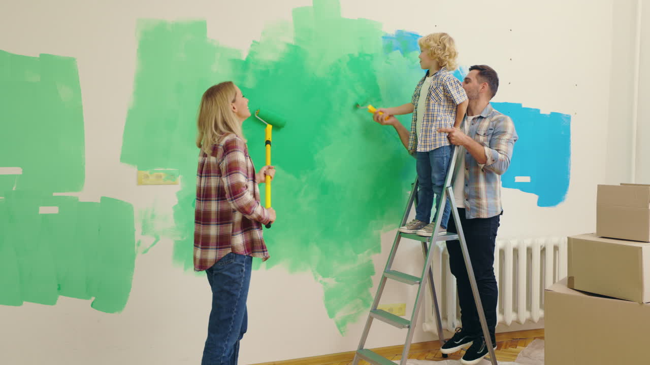 Family Painting a Wall Together in Their New House