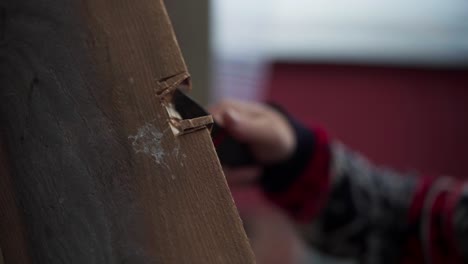 A-Man-Carving-the-Wood-Intended-for-Constructing-a-Greenhouse-in-Indre-Fosen,-Norway---Close-Up