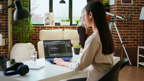 asian freelancer woman works on programming code in a modern office