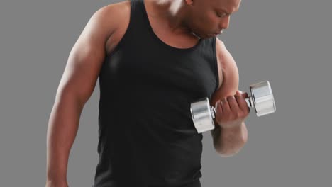 serious muscular man lifting dumbbells