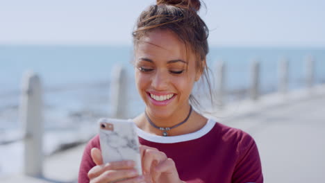 Woman,-face-or-laughing-at-phone-by-beach