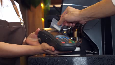 paying with credit card at a coffee shop