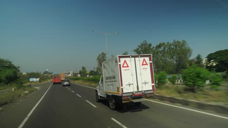 point of view shot of mahindra bolero vaccine van on the highway in maharashtra