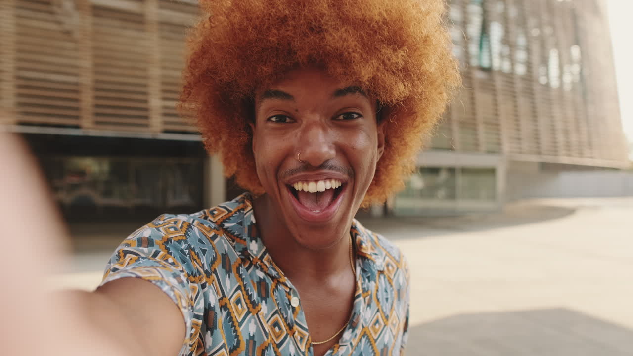 Happy Young Man with Afro Hair Waving at Camera in Selfie Video