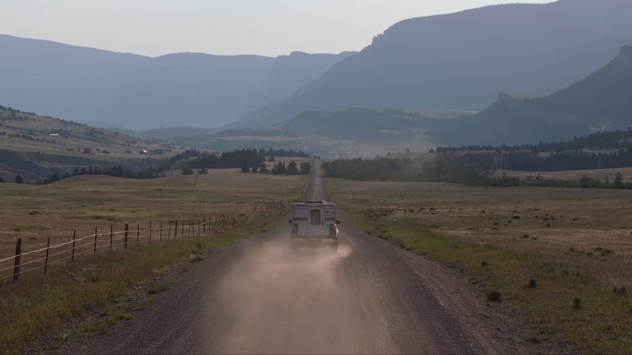 Scenic Drive on a Gravel Road Through a Mountain Valley