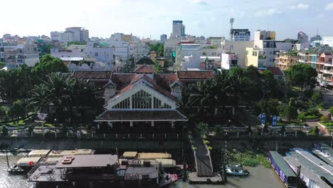 the city of can tho, vietnam featuring boats, river, and architecture from drone on a sunny afternoon