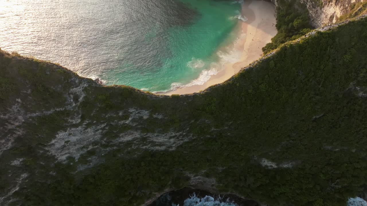 This Mavic 3 Classic drone shot was taken in Nusa Penida's Kelingking Beach (T-Rex Bay) in the sunset (the video framerate is 4K 30 FPS). In the shot you can see the beach and the mountain as well.
