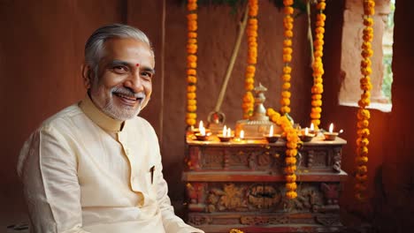 mature indian man wearing traditional clothing, rejoicing during diwali festival, surrounded by illuminating diyas and colorful floral garlands, expressing cultural warmth and spiritual connection