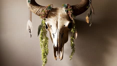 decorated bull skull wall art with flowers and feathers