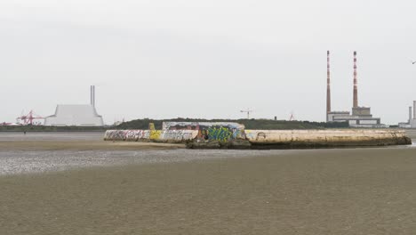 sandymount swimming baths and poolbeg generating station in daytime