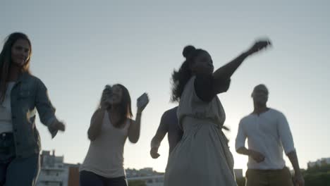 Happy-African-American-woman-dancing-with-friends.