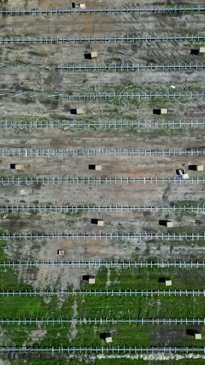 Aerial view of a site where a large solar park is under construction. Vertical shot.