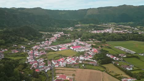 Furnas-village-with-lush-green-landscape-and-mountains-in-azores,-portugal,-aerial-view