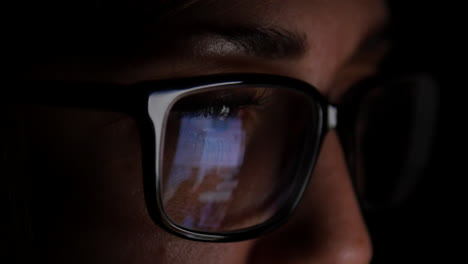 Woman-With-Glasses-Scrolls-Through-Social-Media-At-Night