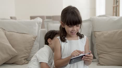 sweet little kids using phone for video talk