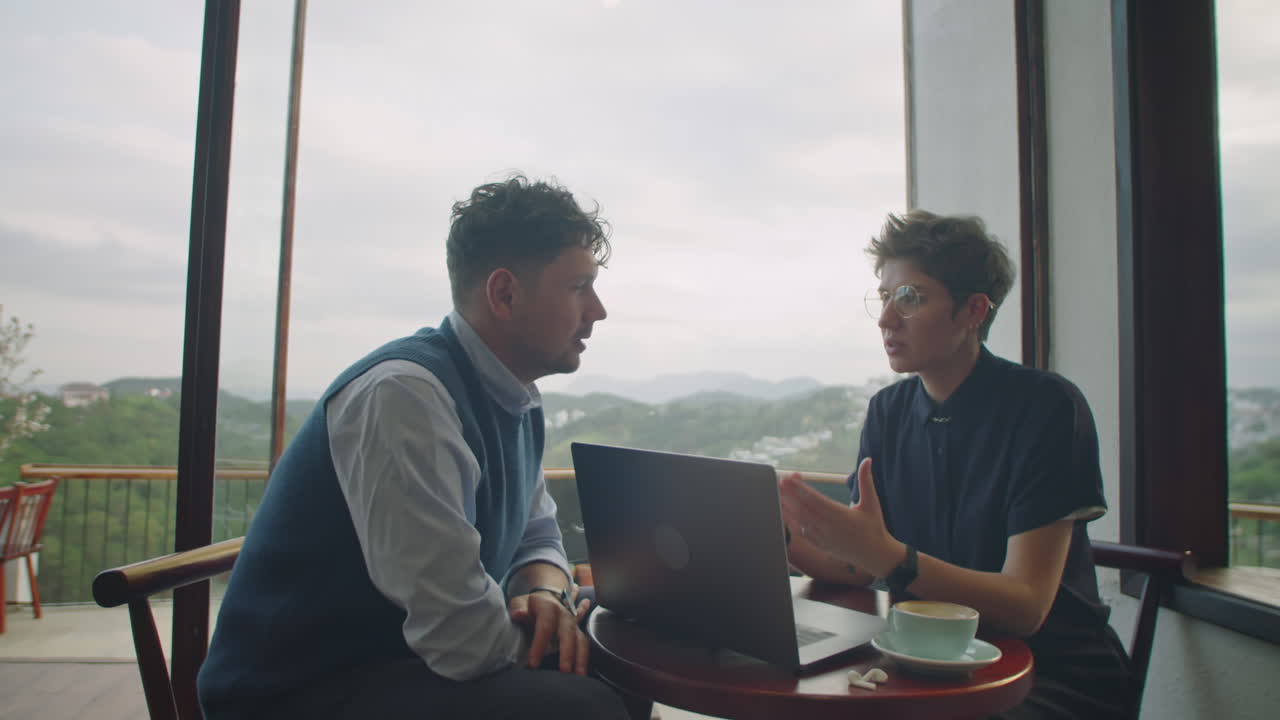 Coworkers Speaking in Cafe with Mountain View