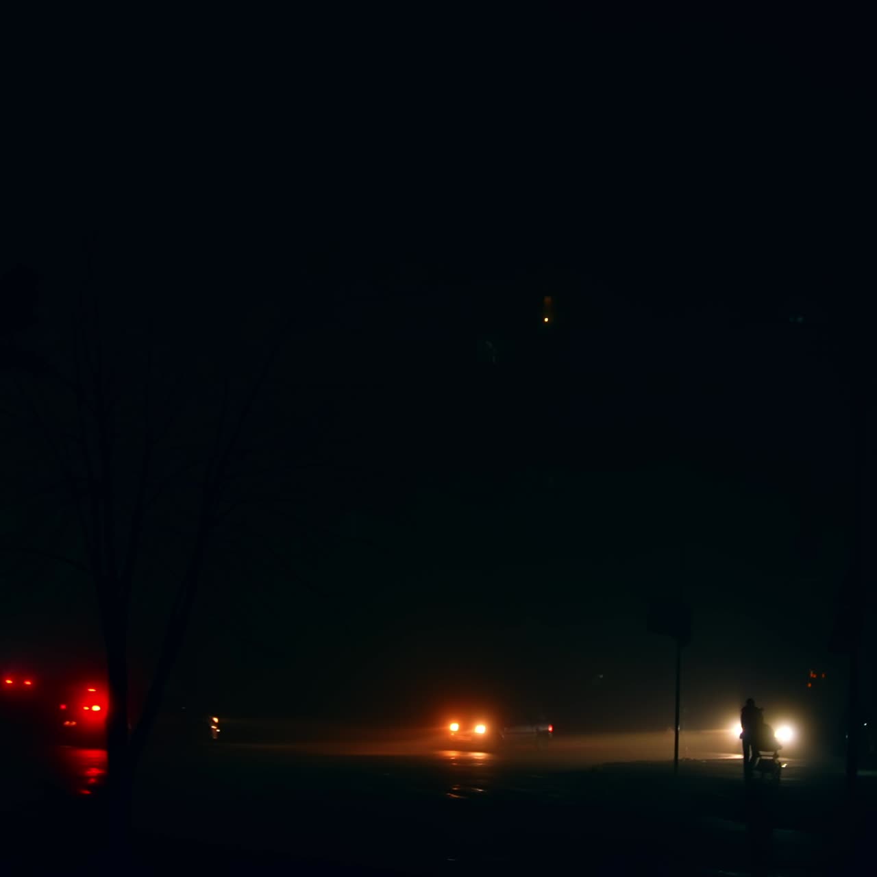 No illumination in the city at night. Power outage and energy crisis in modern metropolis. Lights from cars in the darkness