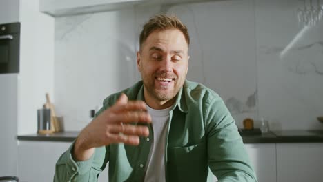 man having a video call in his kitchen