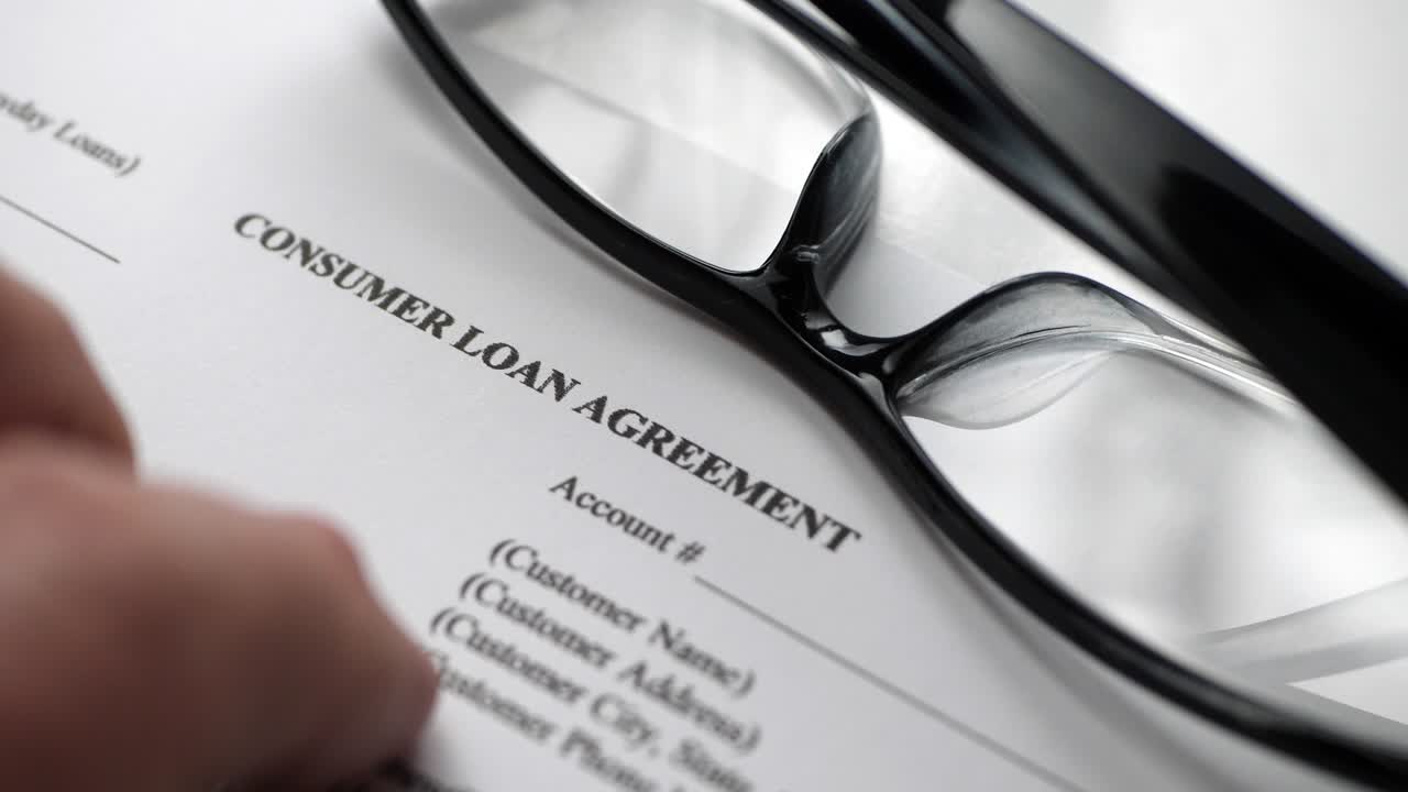Finger tapping on consumer loan agreement
