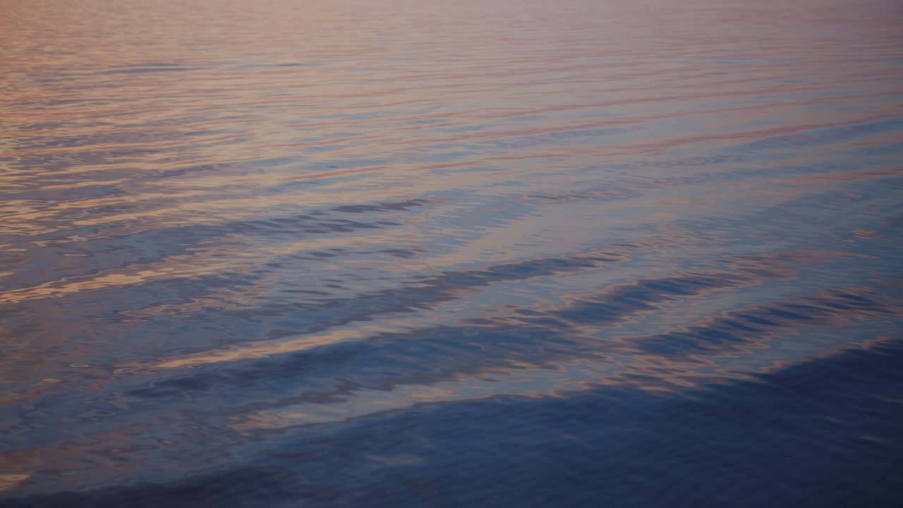 Silky waves on a calm sea in the sunset afterglow
