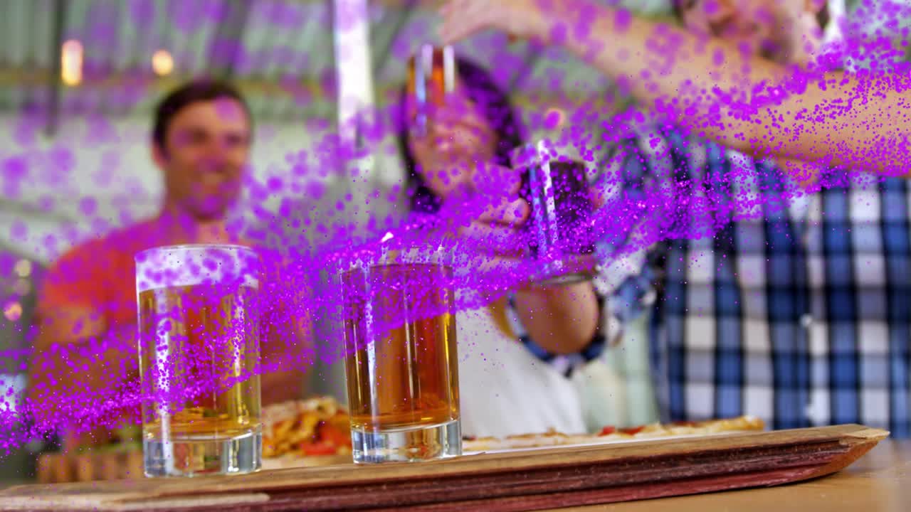Bar patrons cheering and smiling as purple particles sweeping, hand reaching and lifting dark stout