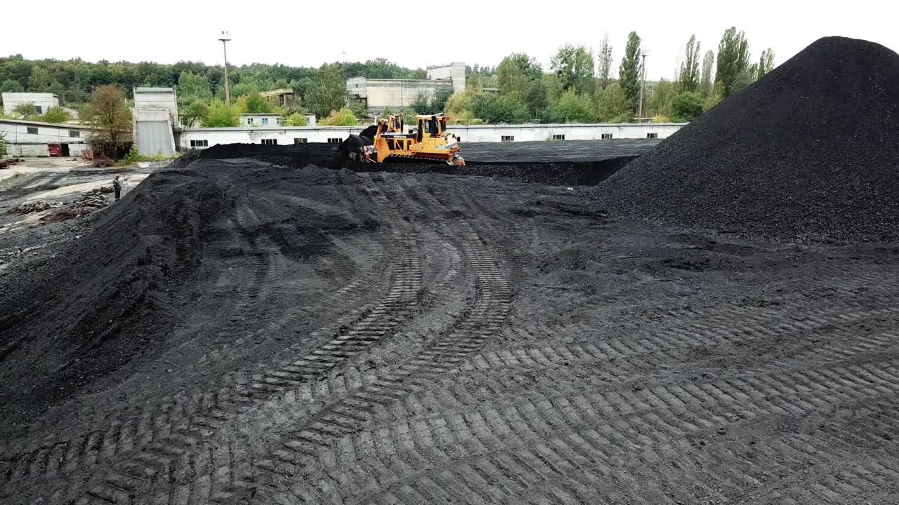 Excavator in coal quarry. Large heavy dump truck for working on coal mine