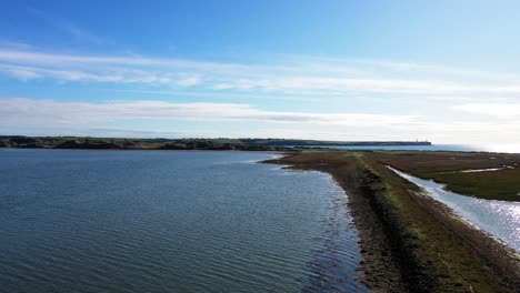 Aerial-flying-near-Tramore-coast-side-in-Waterford,-southeast-Ireland