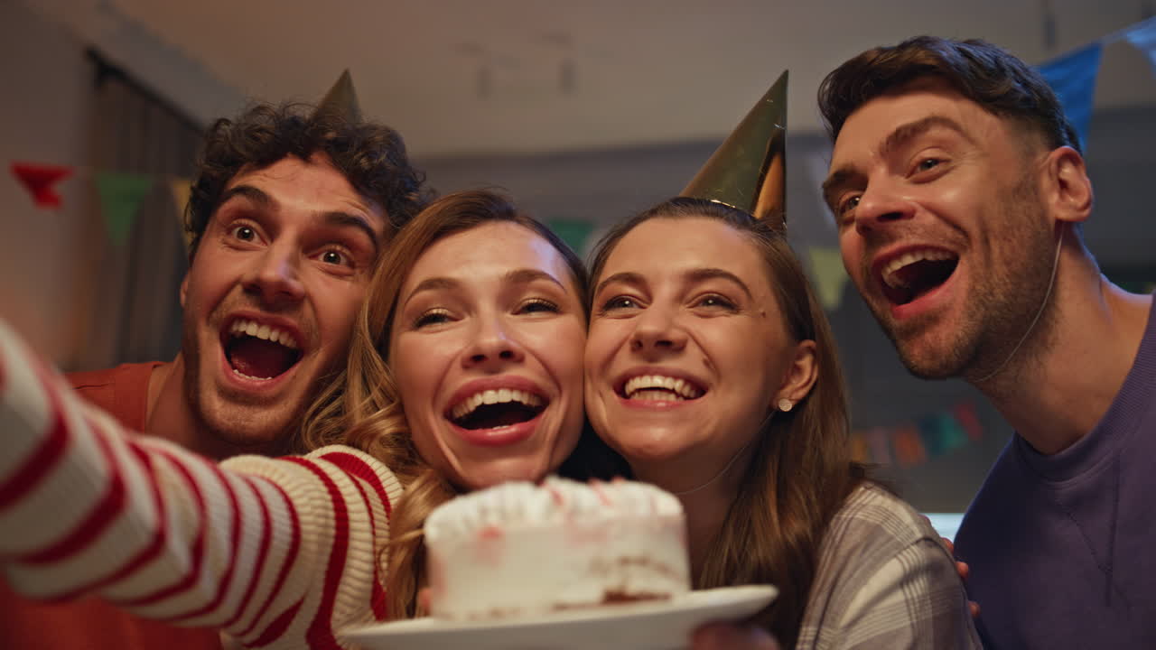 People making selfie birthday party holding cake closeup. Happy smiling friends