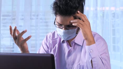 man working on laptop, stressed