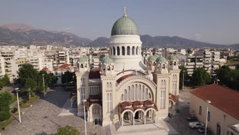 Aerial-orbiting-Impressive-Cathedral-of-Saint-Andrew-in-Patras,-Cityscape-in-Background