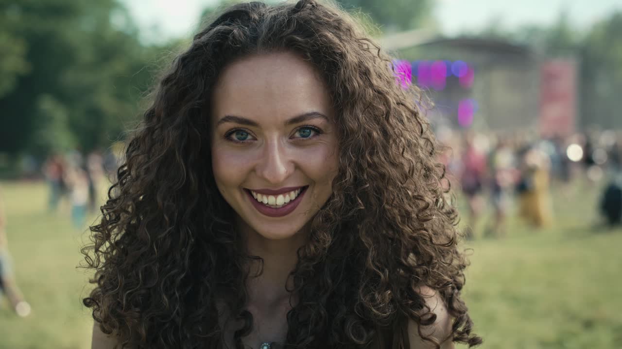 Portrait of smiling young caucasian woman at music festival