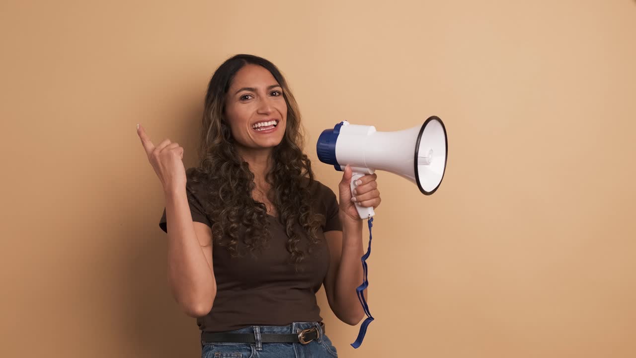 Woman using a loudspeaker and yelling positive