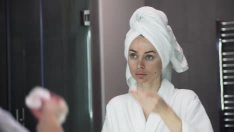 young woman applying toner, using cotton disposable pads, skin care after shower