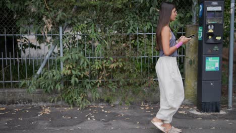 woman walking on the street with smartphone