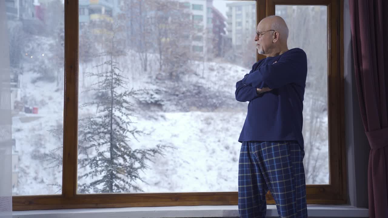el anciano, profundamente pensativo, junto a la ventana en invierno, nota a su joven nieto.