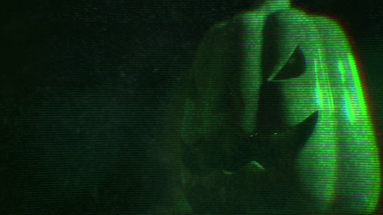 Glitchy Green Jack-o'-Lantern with Retro VHS Distortion Effect