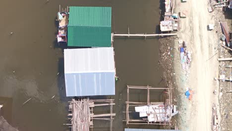 aerial view of houses on stilts in a water village
