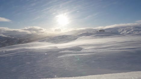 dynamic winter scene with clear skies and sun, snow whirlwind in foreground, norway