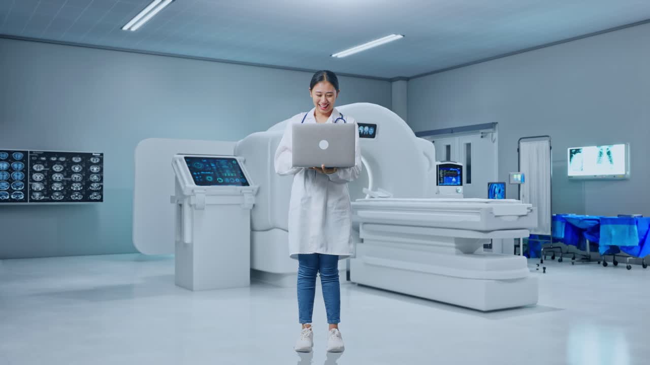 Full Body Of Asian Woman Doctor With Stethoscope Looking At A Laptop And Celebrating The Succeed With Mri Machine In The Hospital