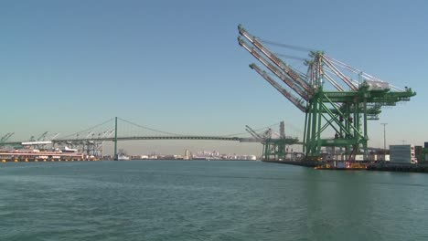 pov shot from a boat of cranes and long beach san pedro harbor scenes