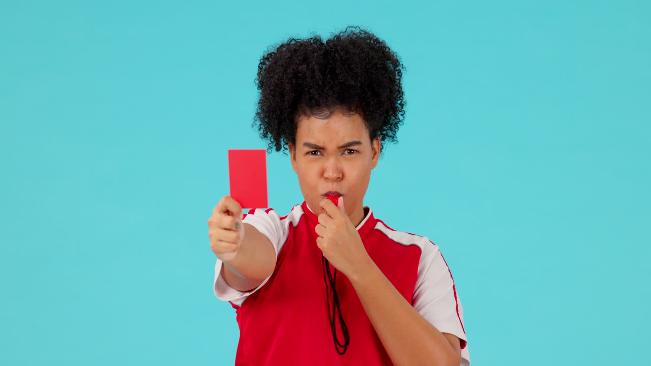Whistle, red card and female referee in a studio