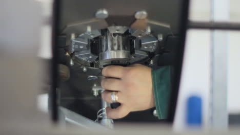 workman changing industrial tool closeup. factory worker inserting adapter