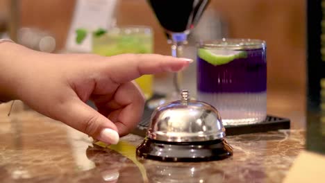 hand ringing bell at bar counter