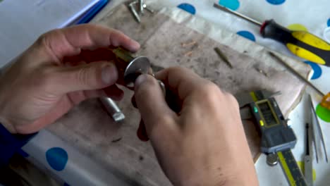 top view locksmith turning key in disassembled lock cylinder