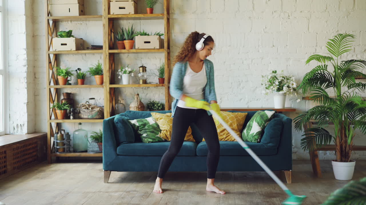 Woman Cleaning and Dancing in Living Room