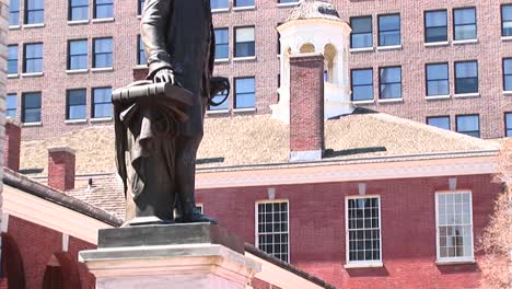 a statue of george washington stands in front of independence hall philadelphia