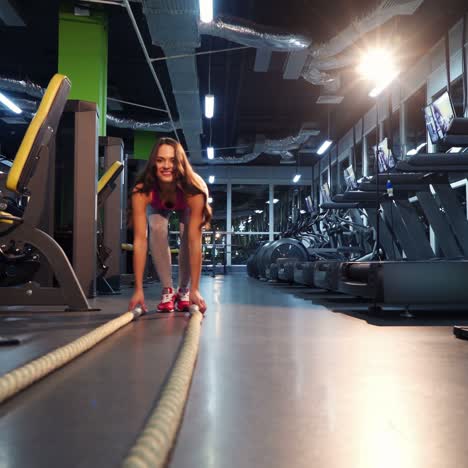 young woman exercising using skipping rope in gym. athletic woman training hard at the gym.
