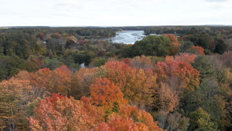 beautiful autumn aerial shot panning up to reveal the royal river running through yarmouth, maine