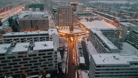 Reverse-aerial-view:-City-crossroad-at-night