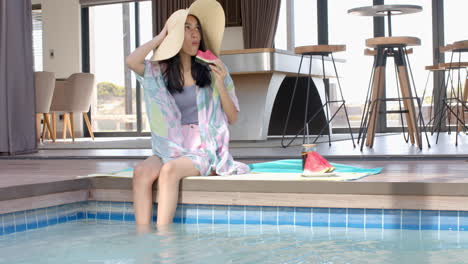 eating watermelon by pool, teenage girl wearing sunhat and relaxing on vacation, copy space